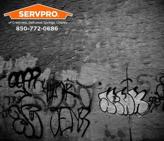 Graffiti is seen on the exterior wall of a commercial business.