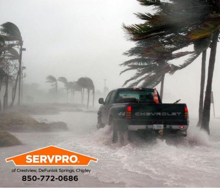 A truck is driving during a storm surge.
