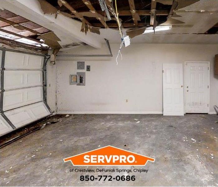 A garage ceiling is damaged by water and mold.