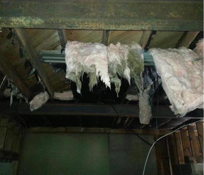 Fire damaged ceiling and insulation falling