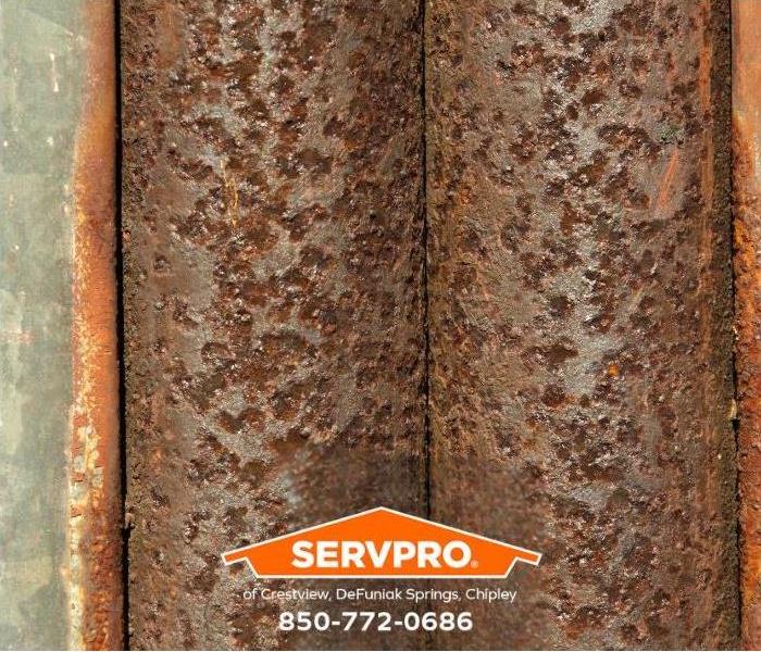 A closeup of corroded pipes is shown.