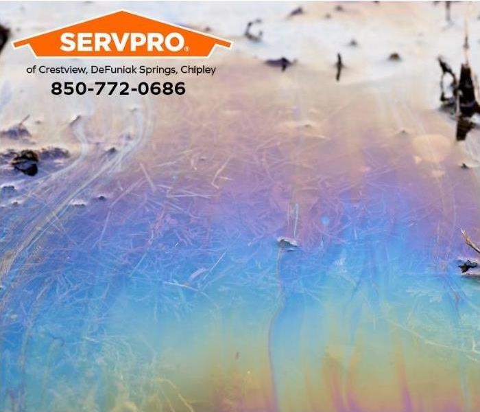 A rainbow of chemicals floods the ground after a chemical spill.